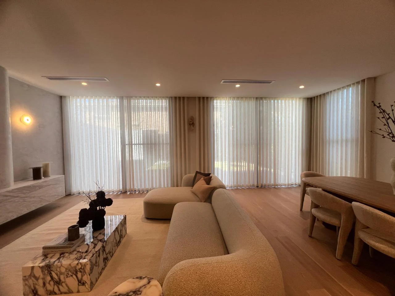 Full-height S-fold sheers around a real furnished living room, supplied by Daman